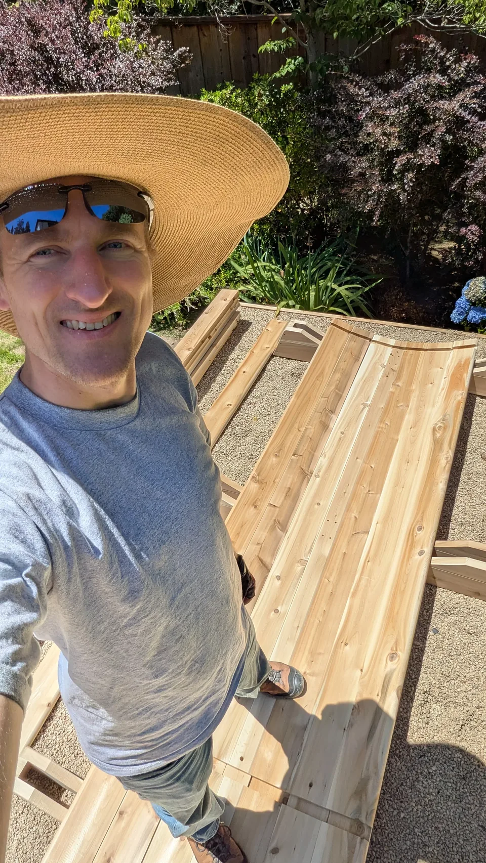 Artem smiling while working on a barrel sauna