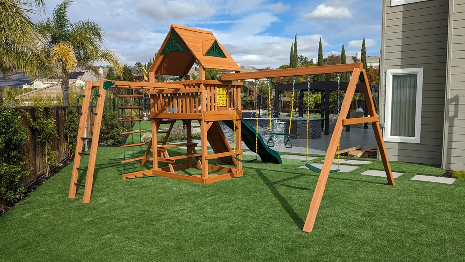 Complete backyard playset assembled by Artem, with covered tower, swings, monkey bars and slide